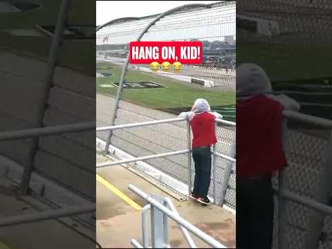 Unbelievable! Kid Struggles to Film as Race Cars Zoom By!